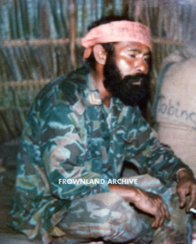 On 17 June 1967, while presiding over one of his last ceremonies as KOPASGAT commander, Air Vice Admiral Wiriadinata introduced a 2-piece camouflage uniform in a unique geometric design [...] This uniform was still being used during Seroja Operation in December 1975 but was apparently phased out shortly after.” — Ken Conboy, Elite: The Special Forces of Indonesia, 1950–2008, 33. This uniform, aka the “Pecah Beling” (literally “broken/shattered glass”) camouflage, was unique to KOPASGAT and remains one of my favorite patterns. It was often seen worn in combination with the KOPASGAT vertical camouflage during field deployments. Photo courtesy of Fokky Fuad, from the collection of Serma (Purn) Ricard Jopy Wokanubun.