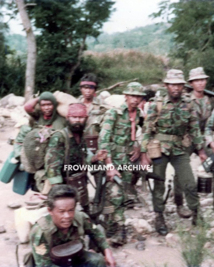 On 17 June 1967, while presiding over one of his last ceremonies as KOPASGAT commander, Air Vice Admiral Wiriadinata introduced a 2-piece camouflage uniform in a unique geometric design [...] This uniform was still being used during Seroja Operation in December 1975 but was apparently phased out shortly after.” — Ken Conboy, Elite: The Special Forces of Indonesia, 1950–2008, 33. This uniform, aka the “Pecah Beling” (literally “broken/shattered glass”) camouflage, was unique to KOPASGAT and remains one of my favorite patterns. It was often seen worn in combination with the KOPASGAT vertical camouflage during field deployments. Photo courtesy of Fokky Fuad, from the collection of Serma (Purn) Ricard Jopy Wokanubun.