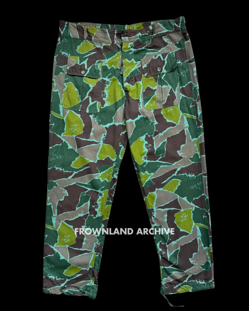 On 17 June 1967, while presiding over one of his last ceremonies as KOPASGAT commander, Air Vice Admiral Wiriadinata introduced a 2-piece camouflage uniform in a unique geometric design [...] This uniform was still being used during Seroja Operation in December 1975 but was apparently phased out shortly after.” — Ken Conboy, Elite: The Special Forces of Indonesia, 1950–2008, 33. This uniform, aka the “Pecah Beling” (literally “broken/shattered glass”) camouflage, was unique to KOPASGAT and remains one of my favorite patterns. It was often seen worn in combination with the KOPASGAT vertical camouflage during field deployments. Photo courtesy of Fokky Fuad, from the collection of Serma (Purn) Ricard Jopy Wokanubun.
