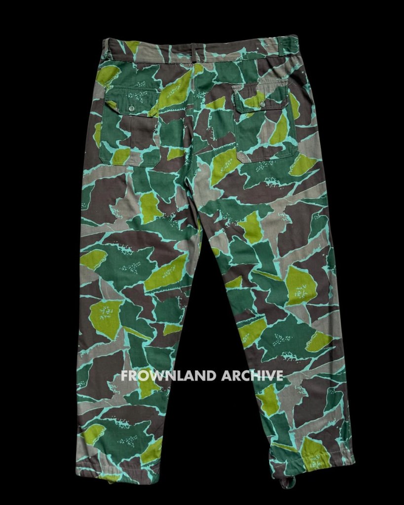 On 17 June 1967, while presiding over one of his last ceremonies as KOPASGAT commander, Air Vice Admiral Wiriadinata introduced a 2-piece camouflage uniform in a unique geometric design [...] This uniform was still being used during Seroja Operation in December 1975 but was apparently phased out shortly after.” — Ken Conboy, Elite: The Special Forces of Indonesia, 1950–2008, 33. This uniform, aka the “Pecah Beling” (literally “broken/shattered glass”) camouflage, was unique to KOPASGAT and remains one of my favorite patterns. It was often seen worn in combination with the KOPASGAT vertical camouflage during field deployments. Photo courtesy of Fokky Fuad, from the collection of Serma (Purn) Ricard Jopy Wokanubun.