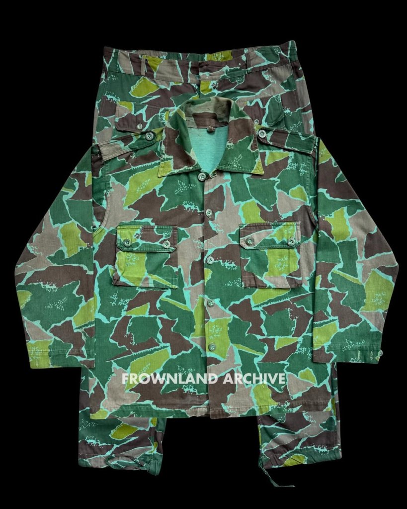 On 17 June 1967, while presiding over one of his last ceremonies as KOPASGAT commander, Air Vice Admiral Wiriadinata introduced a 2-piece camouflage uniform in a unique geometric design [...] This uniform was still being used during Seroja Operation in December 1975 but was apparently phased out shortly after.” — Ken Conboy, Elite: The Special Forces of Indonesia, 1950–2008, 33. This uniform, aka the “Pecah Beling” (literally “broken/shattered glass”) camouflage, was unique to KOPASGAT and remains one of my favorite patterns. It was often seen worn in combination with the KOPASGAT vertical camouflage during field deployments. Photo courtesy of Fokky Fuad, from the collection of Serma (Purn) Ricard Jopy Wokanubun.